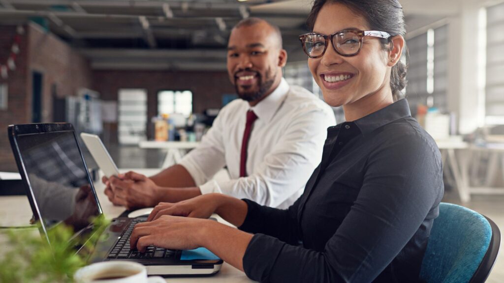 Team members on laptop working in business