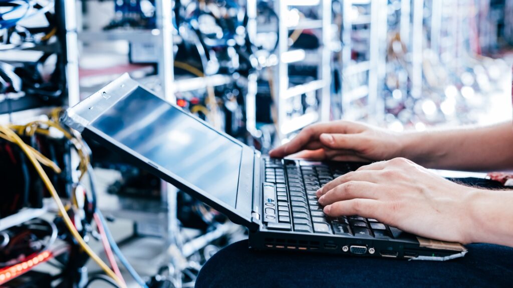 IT solutions engineer working in server room