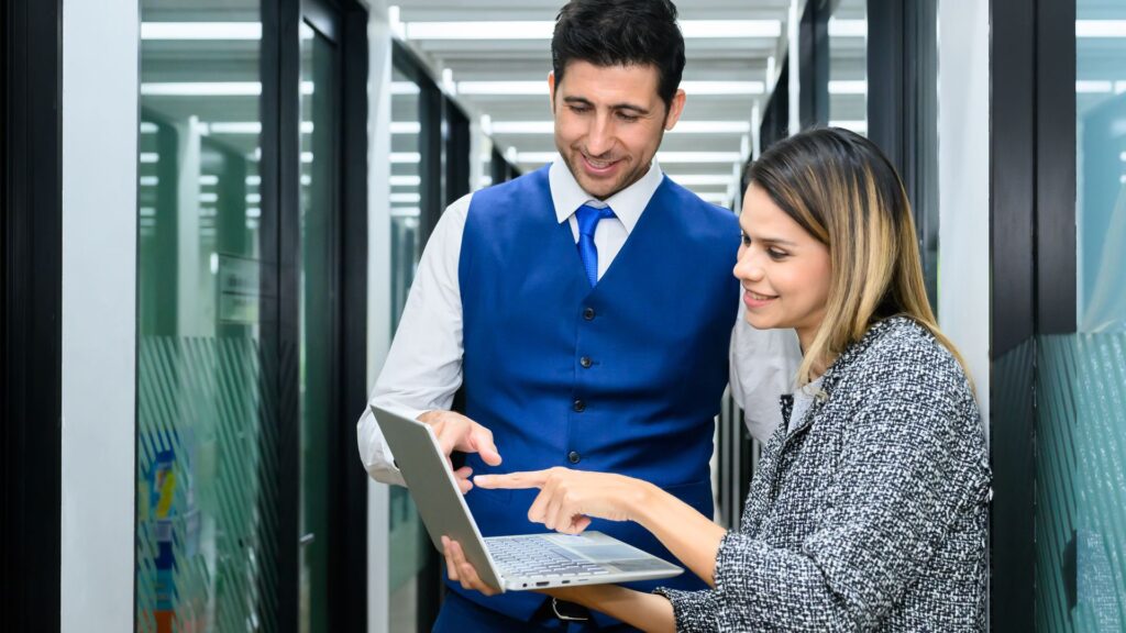 IT technicians on laptop in data center