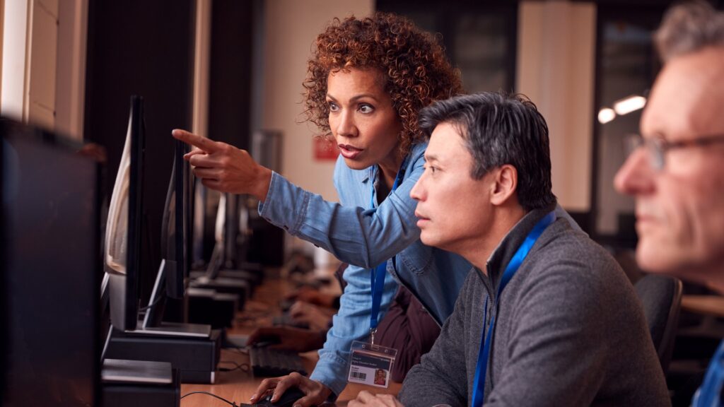 technician in IT assisting on computer